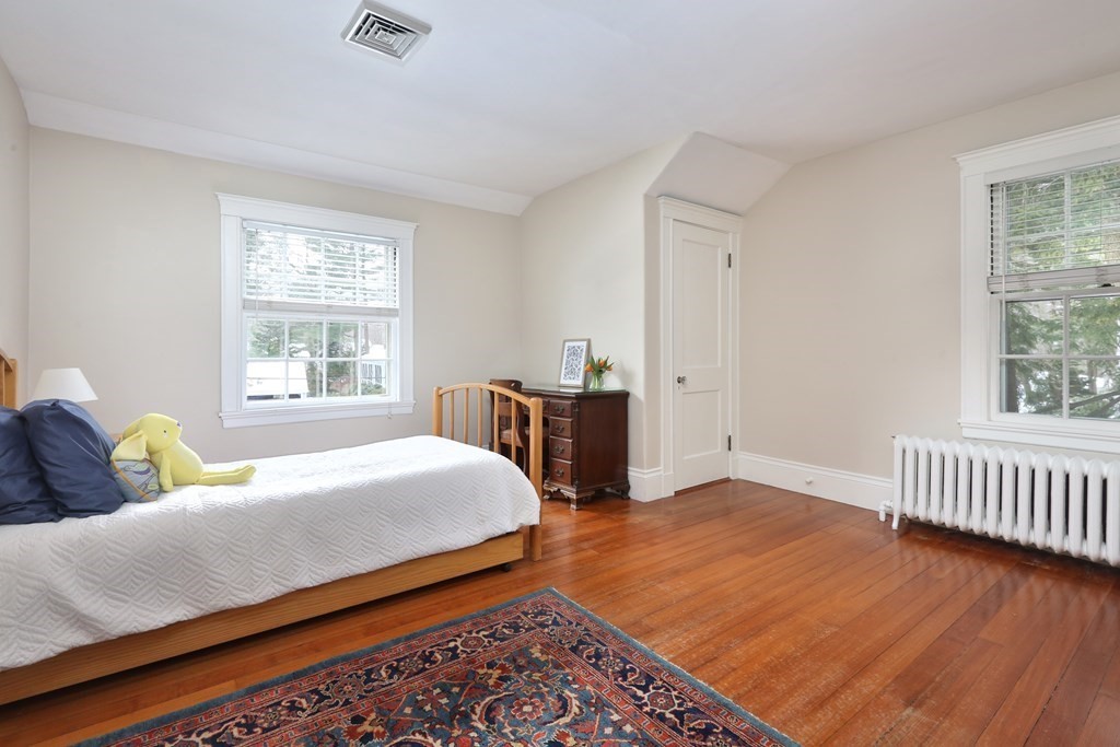34 Livermore Road Wellesley, MA 02481 - Photo 27 of 36 a bedroom with a bed and wooden floor