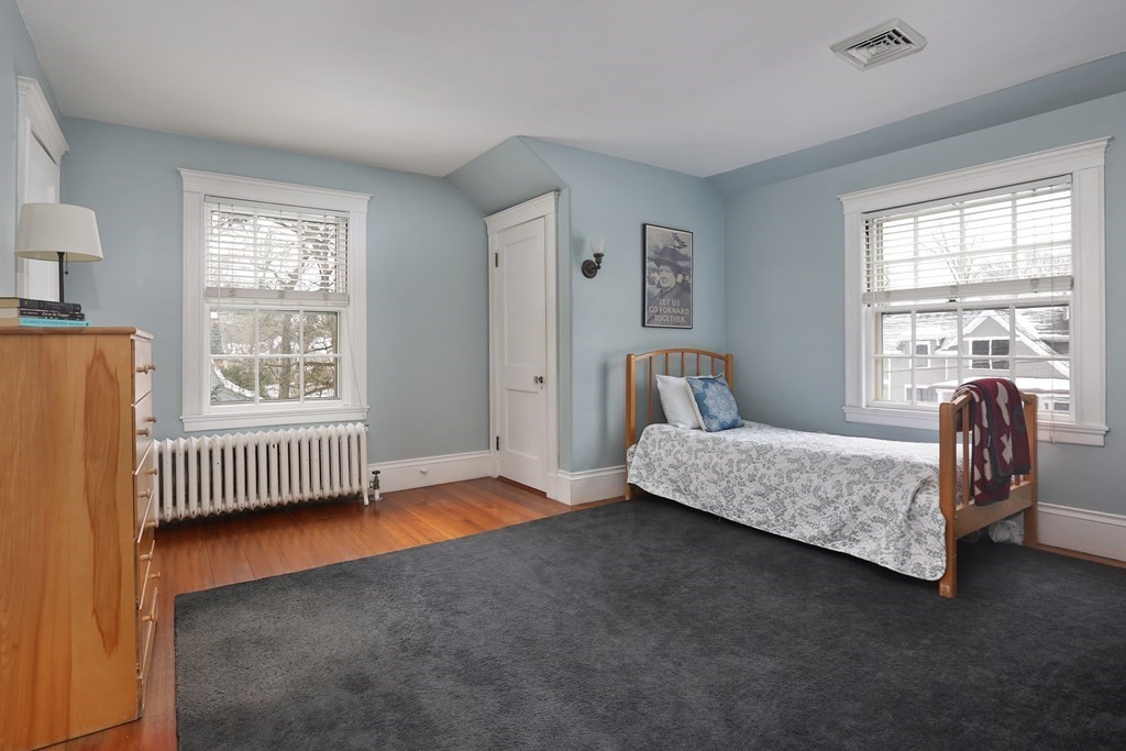 34 Livermore Road Wellesley, MA 02481 - Photo 28 of 36 a bedroom with a bed and a chair