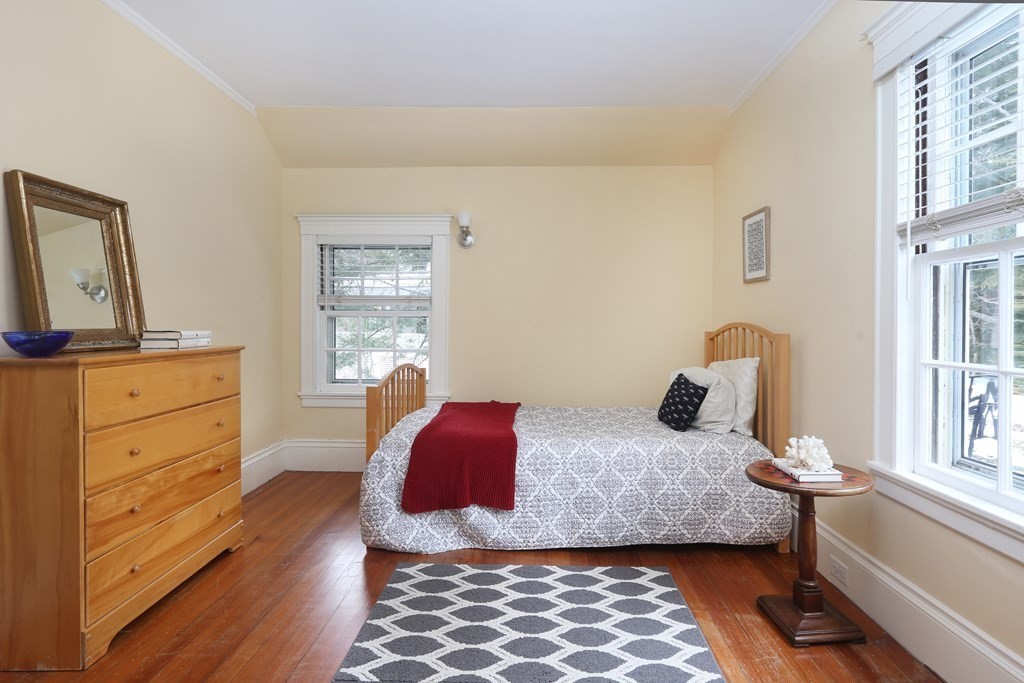 34 Livermore Road Wellesley, MA 02481 - Photo 29 of 36 a bedroom with a bed and wooden floor