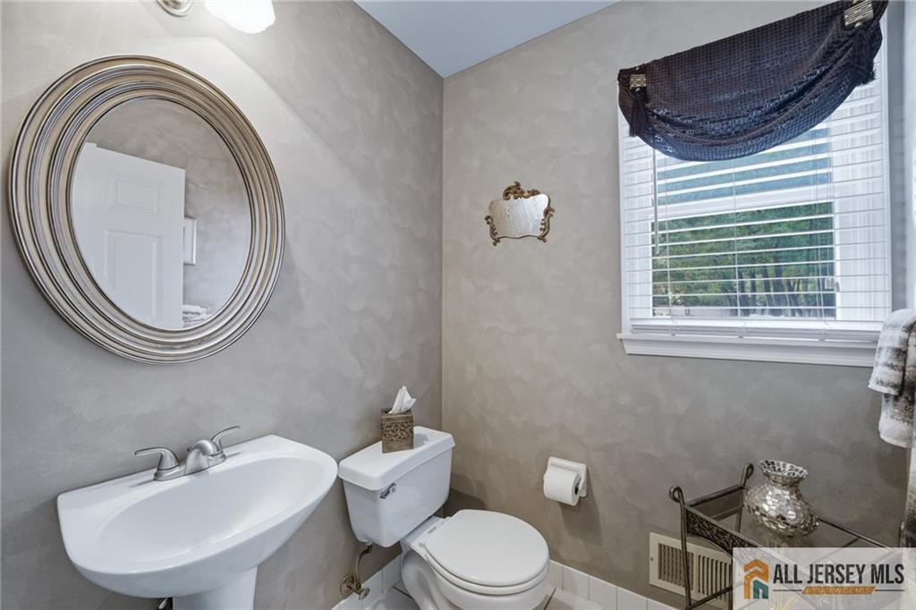 2 Guinevere Road Monroe Township, NJ 08831 - Photo 17 of 40 a bathroom with a sink a toilet and a mirror