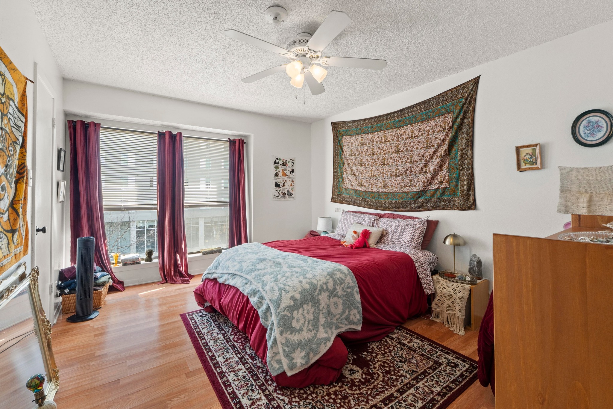 2110 Rio Grande Street, Unit 303 Austin, TX 78705 - Photo 15 of 22 Bedroom with light wood finished floors, a textured ceiling, and a ceiling fan