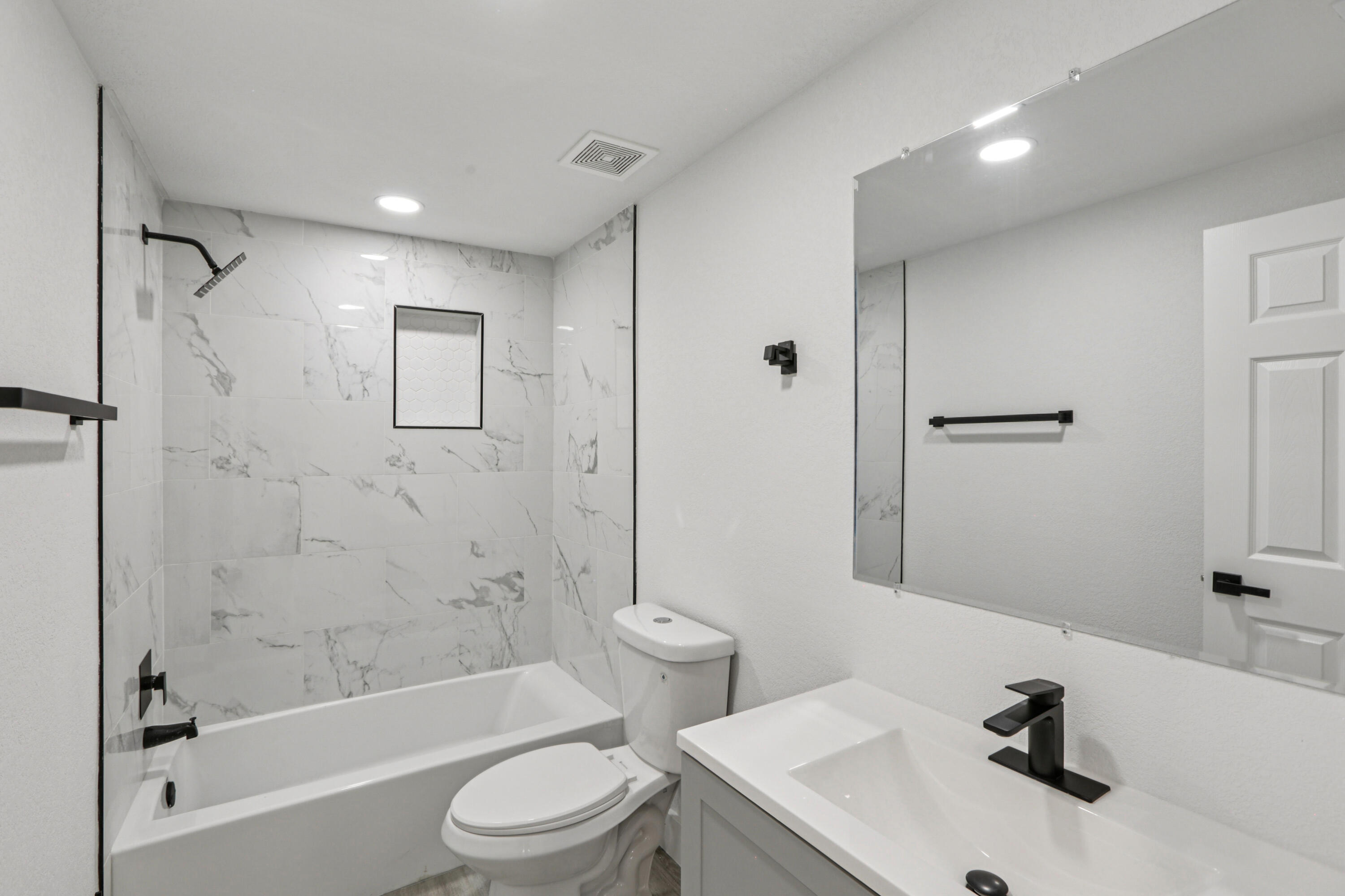 4946 Avery Road New Port Richey, FL 34652 - Photo 6 of 10 a bathroom with a sink toilet and shower