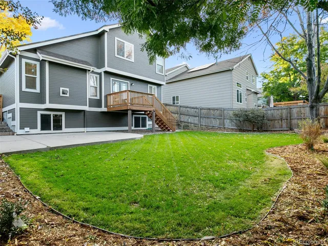 a view of house with backyard