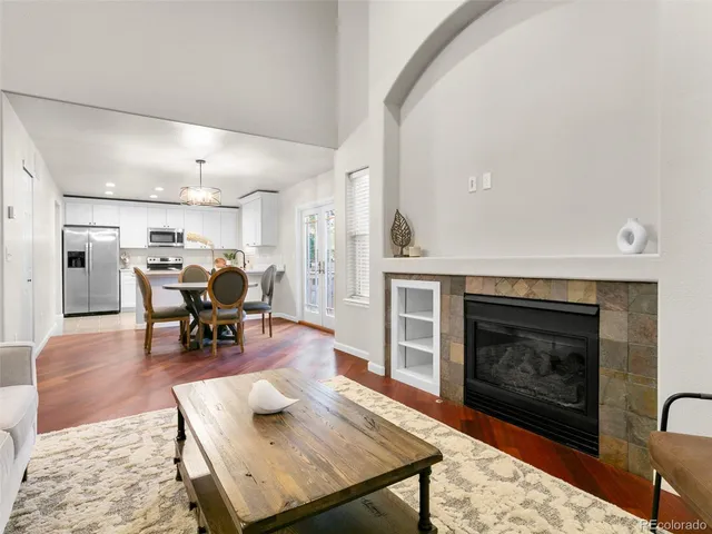 a living room with furniture and fireplace with wooden floor