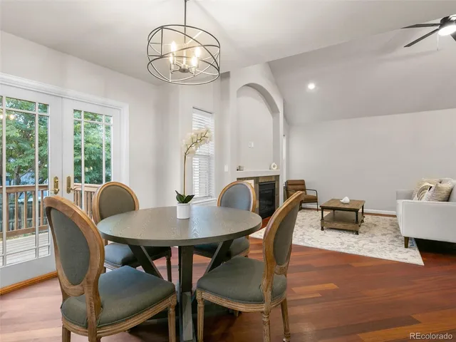 a view of a dining room with furniture a chandelier and wooden floor