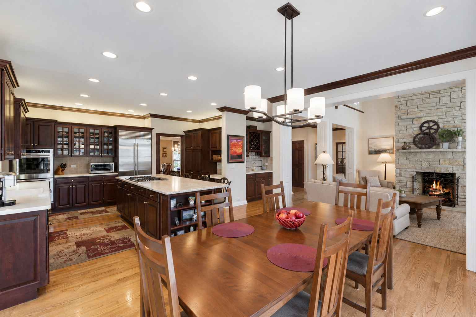 209 Carriage Trail Barrington, IL 60010 - Photo 11 of 42 a kitchen with stainless steel appliances kitchen island granite countertop a table chairs and a view of living room