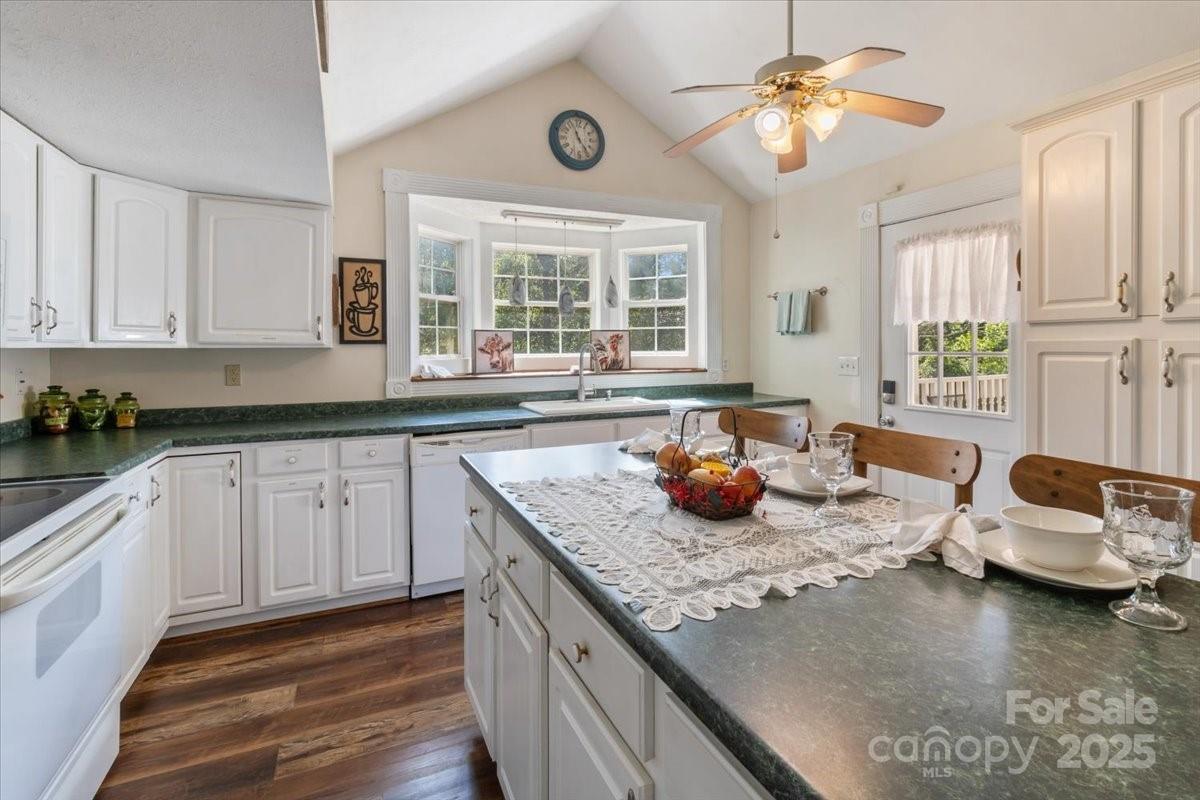201 Murphy Hill Road Weaverville, NC 28787 - Photo 20 of 48 a kitchen with stainless steel appliances granite countertop a sink dishwasher stove and cabinets with wooden floor