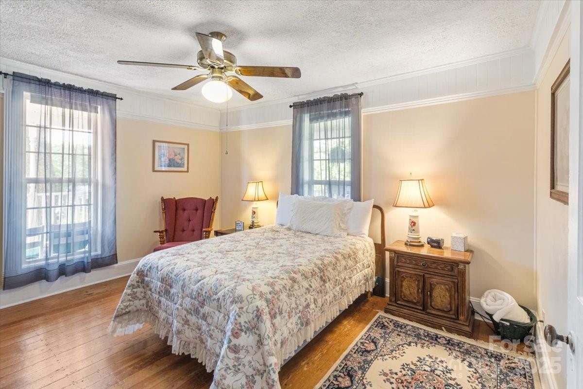 201 Murphy Hill Road Weaverville, NC 28787 - Photo 24 of 48 a bedroom with a bed and wooden floor