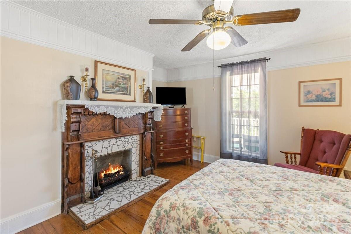 201 Murphy Hill Road Weaverville, NC 28787 - Photo 25 of 48 a bedroom with a bed and a fireplace