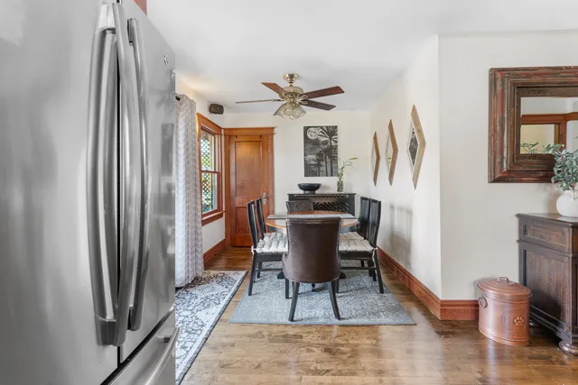 a dining room with furniture a chandelier and wooden floor