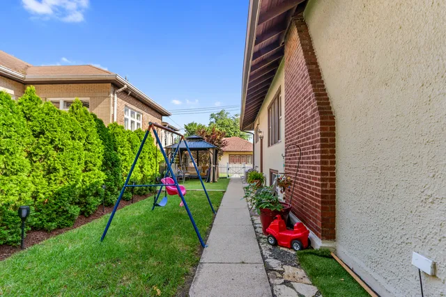 a view of a backyard with a garden and entertaining space