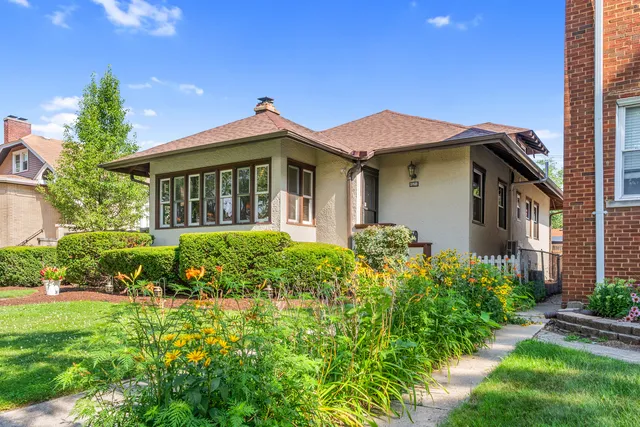 an aerial view of residential house with outdoor space and trees all around