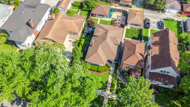 an aerial view of a house with garden space and street view