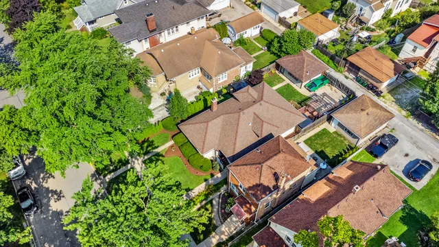an aerial view of a house with a garden and lake view