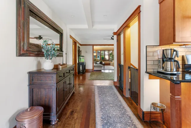 a view of a hallway with furniture and windows