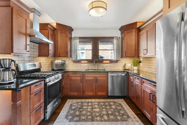 a kitchen with stainless steel appliances granite countertop a stove a sink dishwasher and a microwave