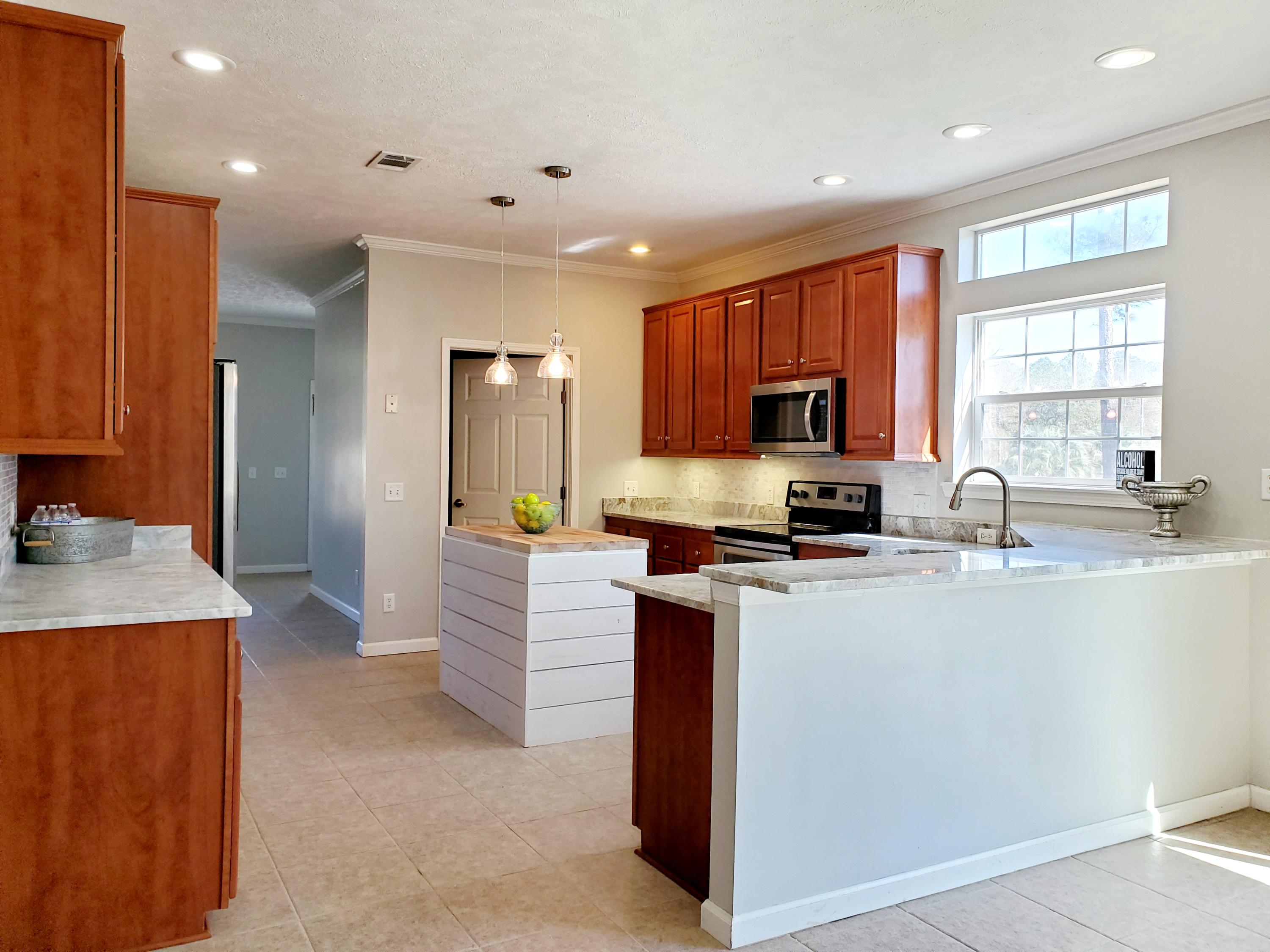 456 East Nursery Road Santa Rosa Beach, FL 32459 - Photo 2 of 21 a kitchen with stainless steel appliances granite countertop a sink stove and refrigerator