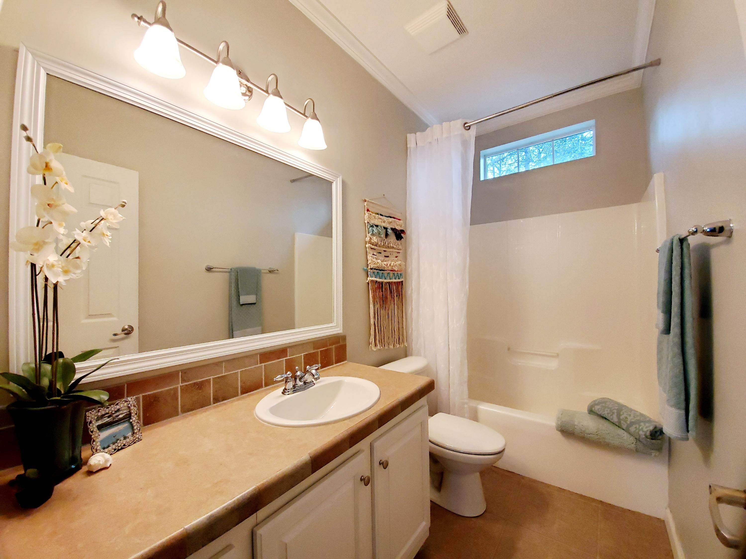 456 East Nursery Road Santa Rosa Beach, FL 32459 - Photo 15 of 21 a bathroom with a sink and a mirror