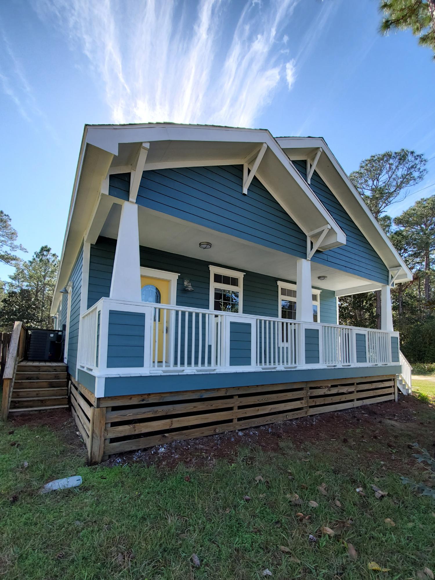 456 East Nursery Road Santa Rosa Beach, FL 32459 - Photo 18 of 21 a front view of a house with a small yard and wooden fence