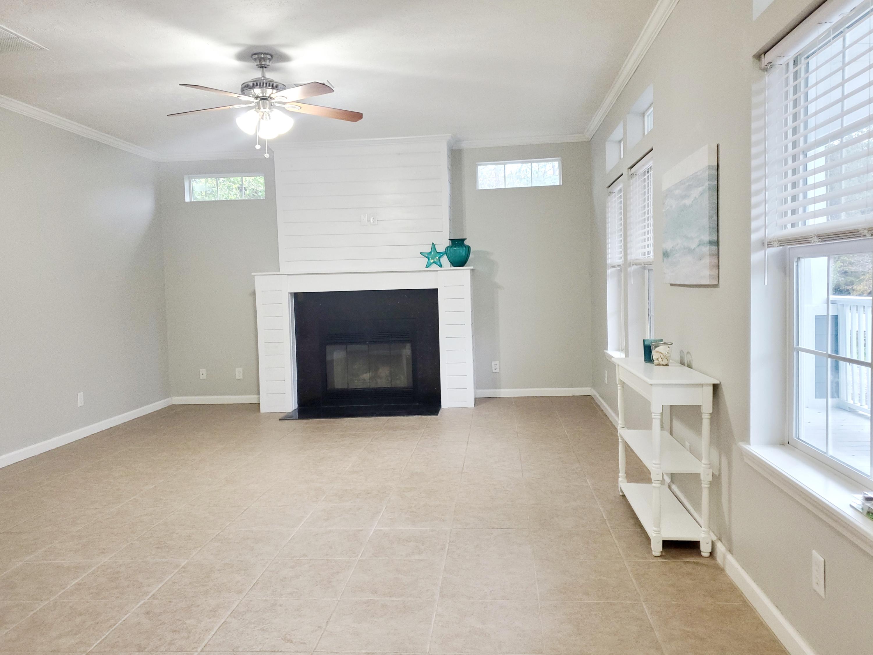 456 East Nursery Road Santa Rosa Beach, FL 32459 - Photo 6 of 21 a view of an empty room with a fireplace and a window