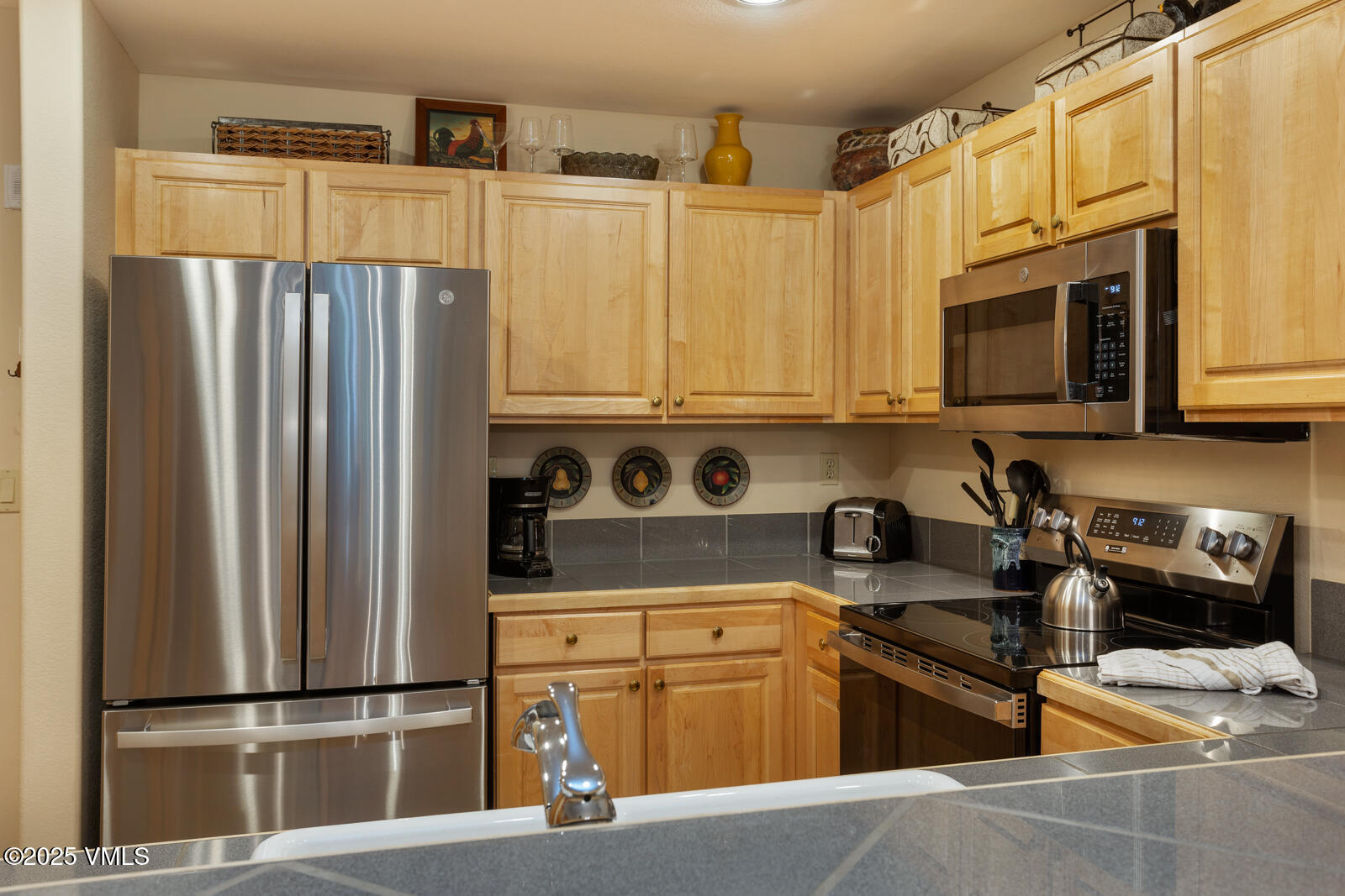74 Cresta Road, Unit 106 Edwards, CO 81632 - Photo 5 of 22 a kitchen with stainless steel appliances granite countertop a refrigerator sink and stove