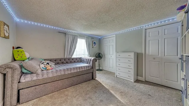 a bedroom with a bed and a cabinets