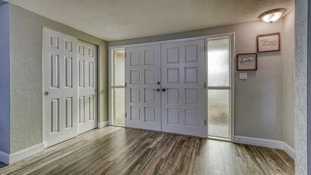 a view of a hallway with wooden floor