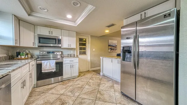 a kitchen with a refrigerator sink and stainless steel appliances