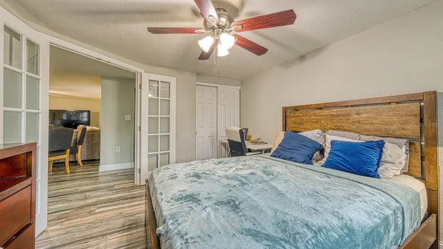 a bedroom with a bed and a chandelier