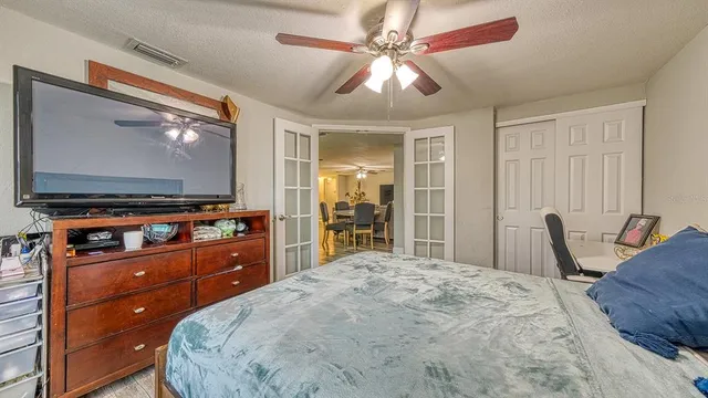 a bedroom with a bed and a flat screen tv