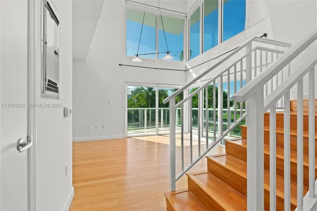 a view of staircase with white walls and windows