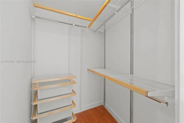 a view of walk in closet with empty racks