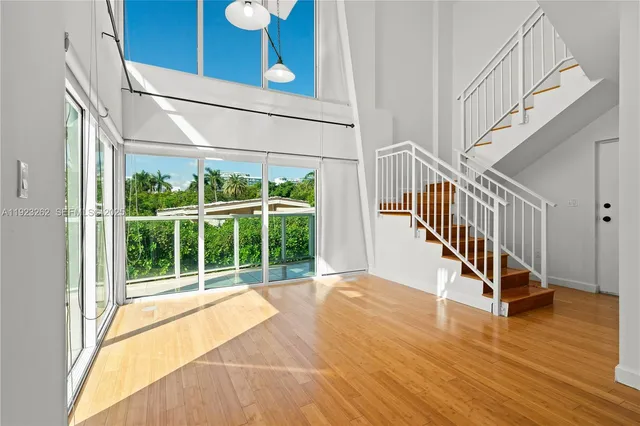 a view of an entryway with wooden floor
