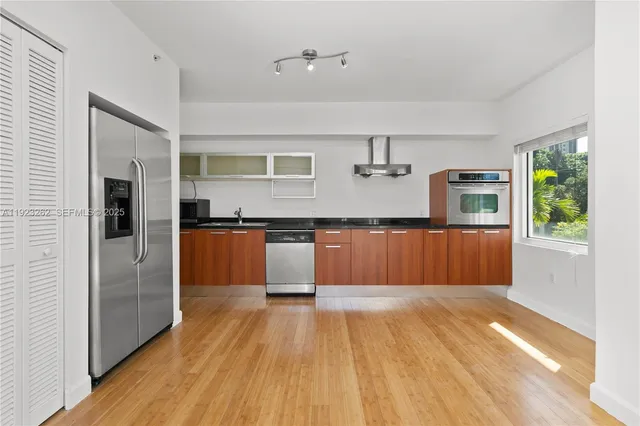 a large kitchen with cabinets and stainless steel appliances