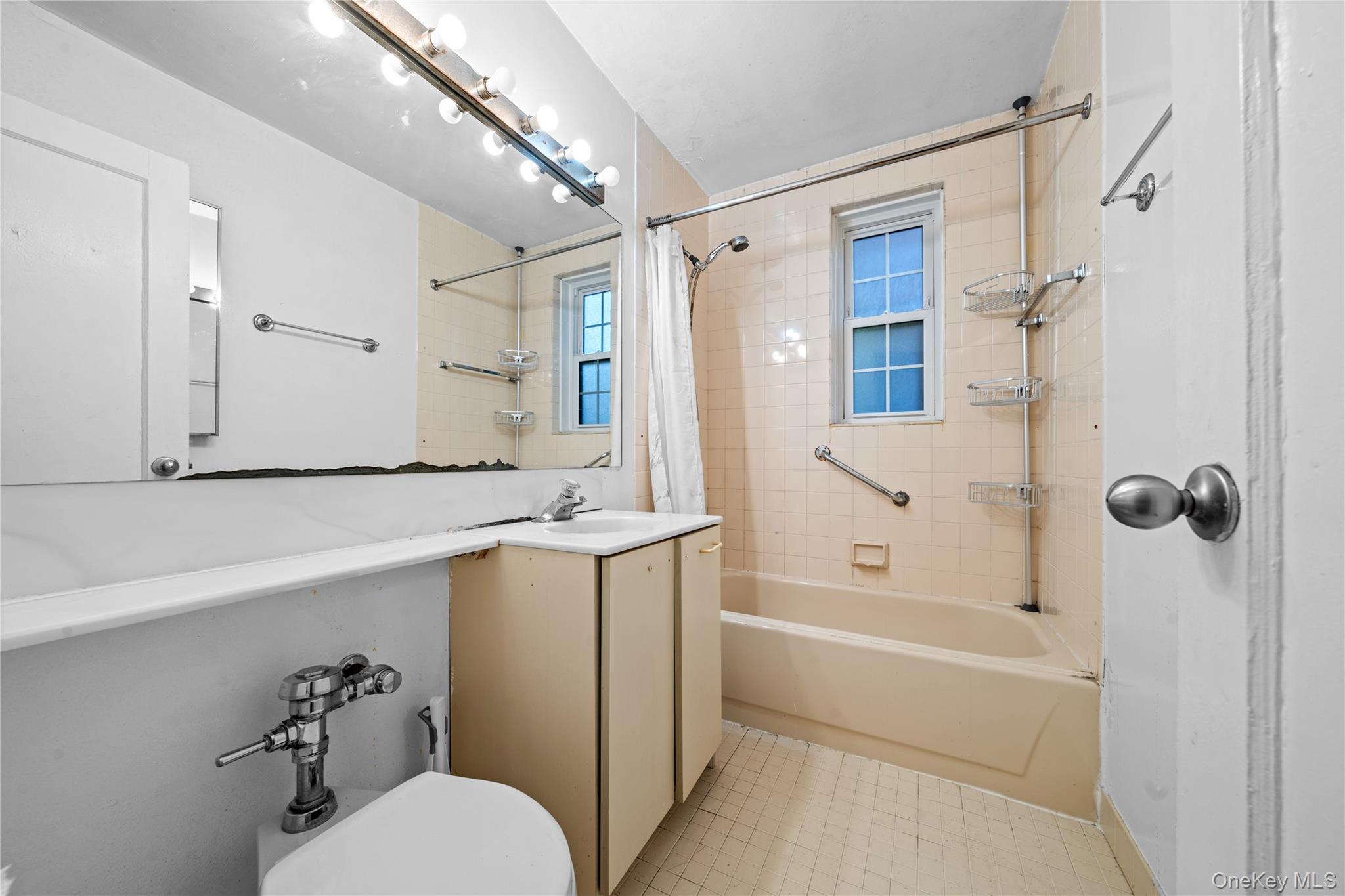 140-18 Burden Crescent, Unit 305 Queens, NY 11435 - Photo 11 of 15 a bathroom with a sink a toilet and shower