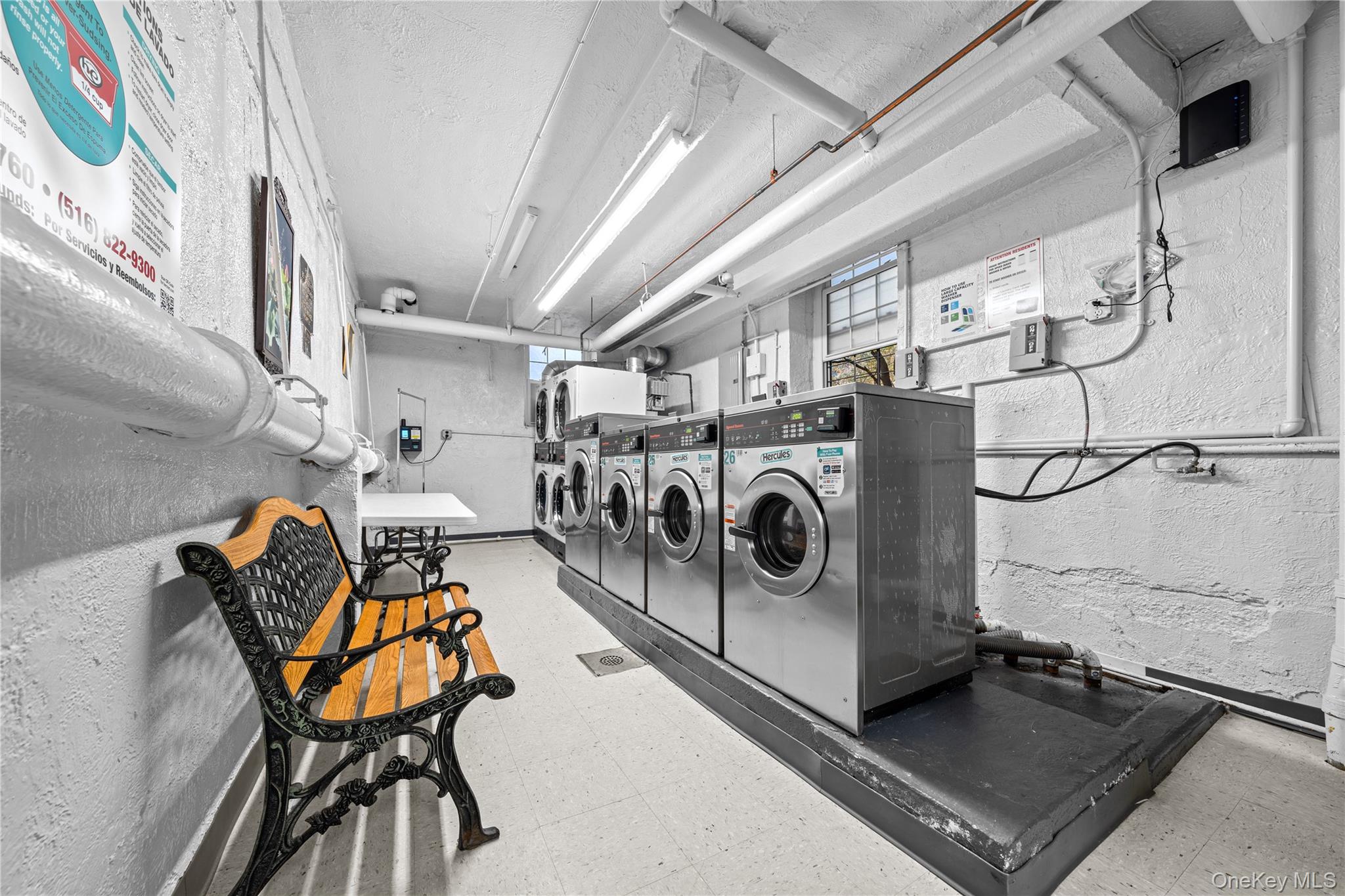 140-18 Burden Crescent, Unit 305 Queens, NY 11435 - Photo 13 of 15 a utility room with dryer and washer