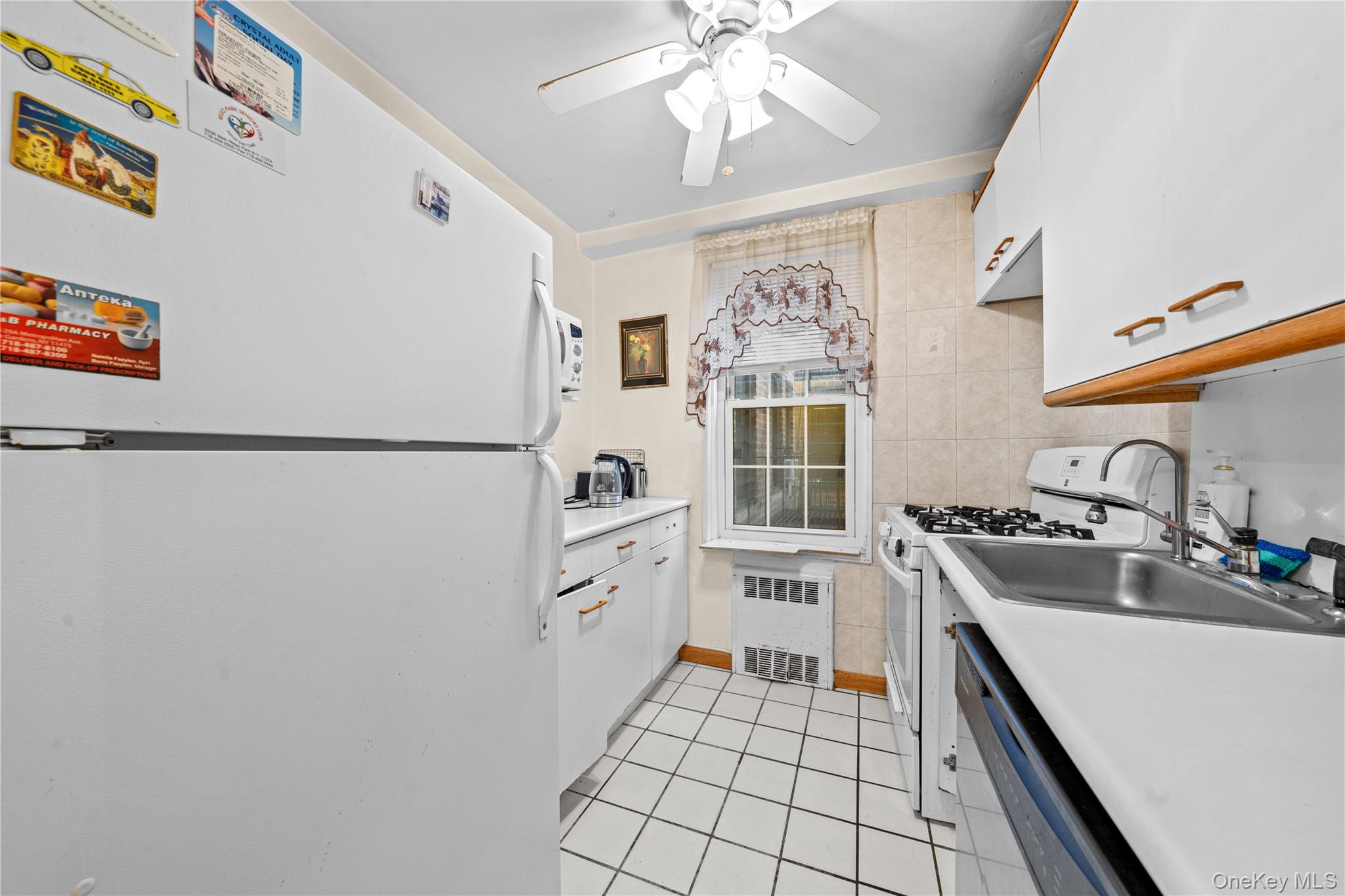 140-18 Burden Crescent, Unit 305 Queens, NY 11435 - Photo 10 of 15 a kitchen with stainless steel appliances a sink stove and cabinets