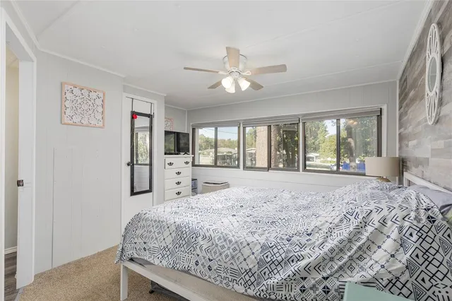 a bed sitting in a room next to a window