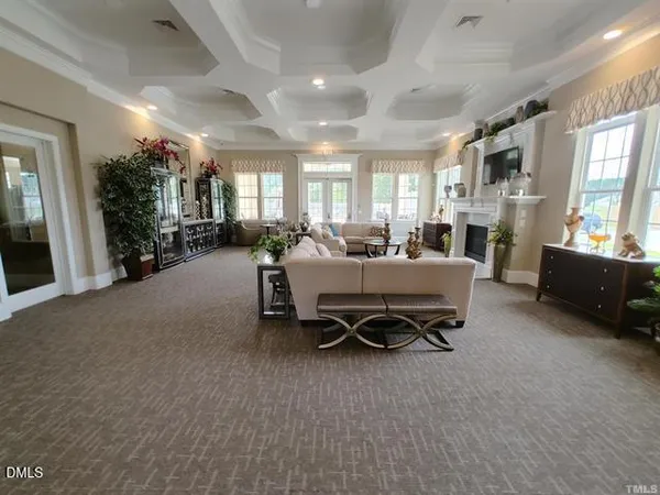 a room with furniture pool table flat screen tv and windows
