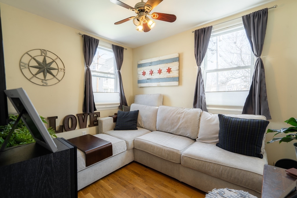 328 Beacon Street, Unit 1F Somerville, MA 02143 - Photo 4 of 10 a living room with furniture and a large window