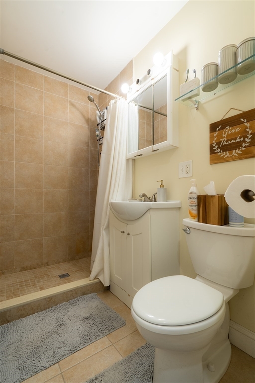 328 Beacon Street, Unit 1F Somerville, MA 02143 - Photo 5 of 10 a bathroom with a sink a toilet and shower