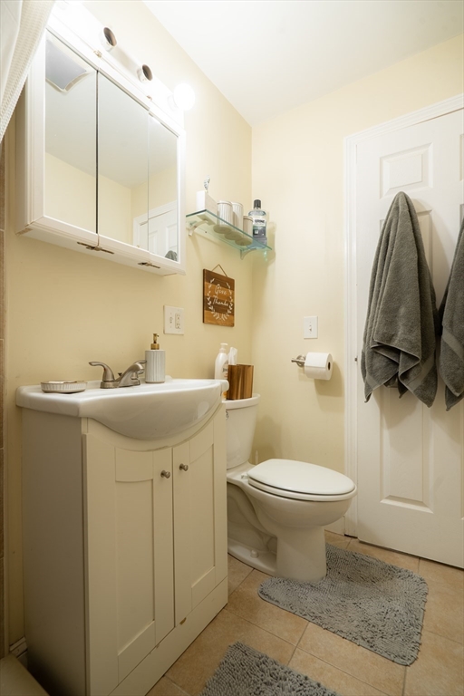 328 Beacon Street, Unit 1F Somerville, MA 02143 - Photo 6 of 10 a bathroom with a sink toilet and mirror