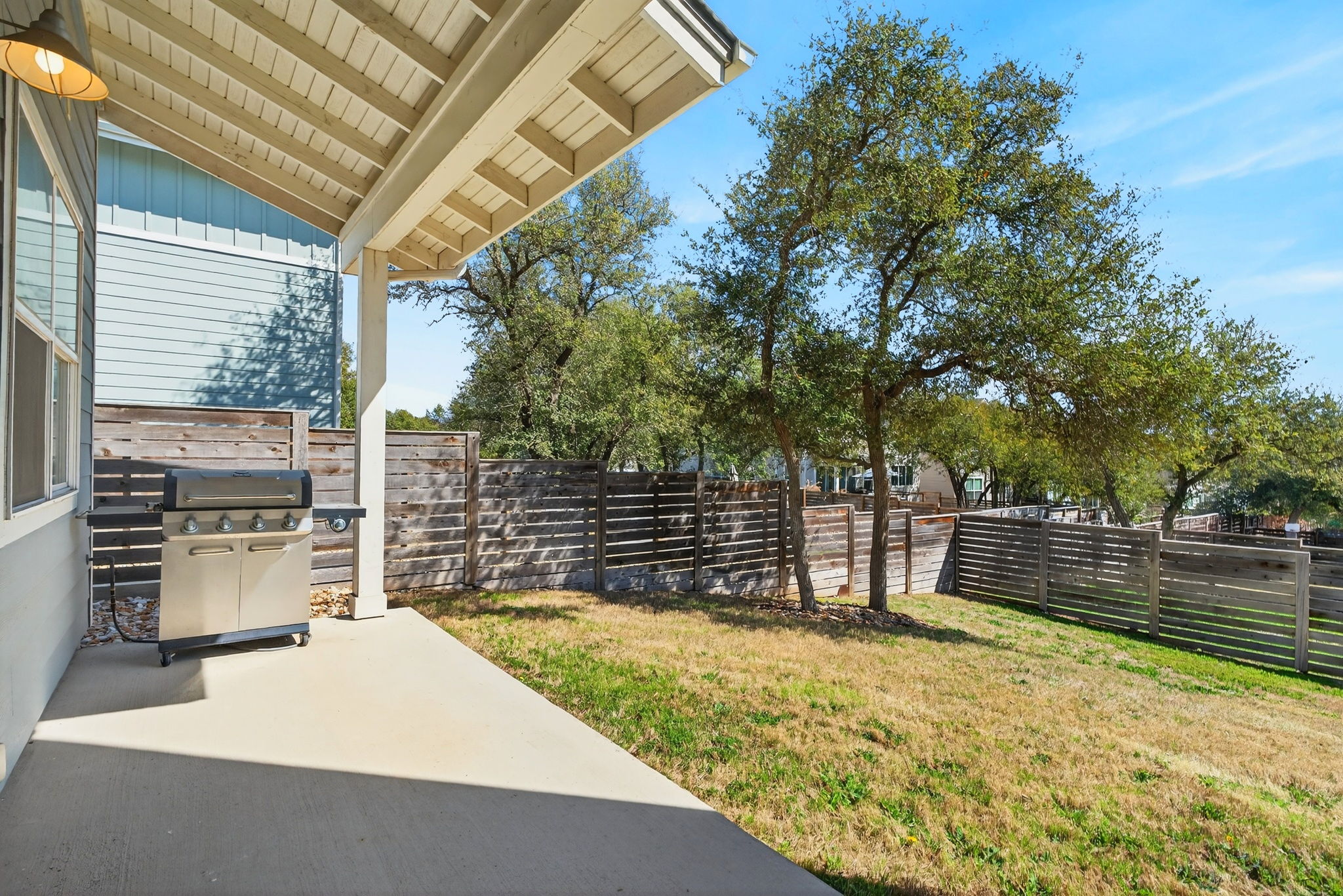 7803 Ryans Way Austin, TX 78726 - Photo 30 of 38 A covered patio provides shade for year-round outdoor enjoyment. The built-in gas stub is ready for your grill setup.