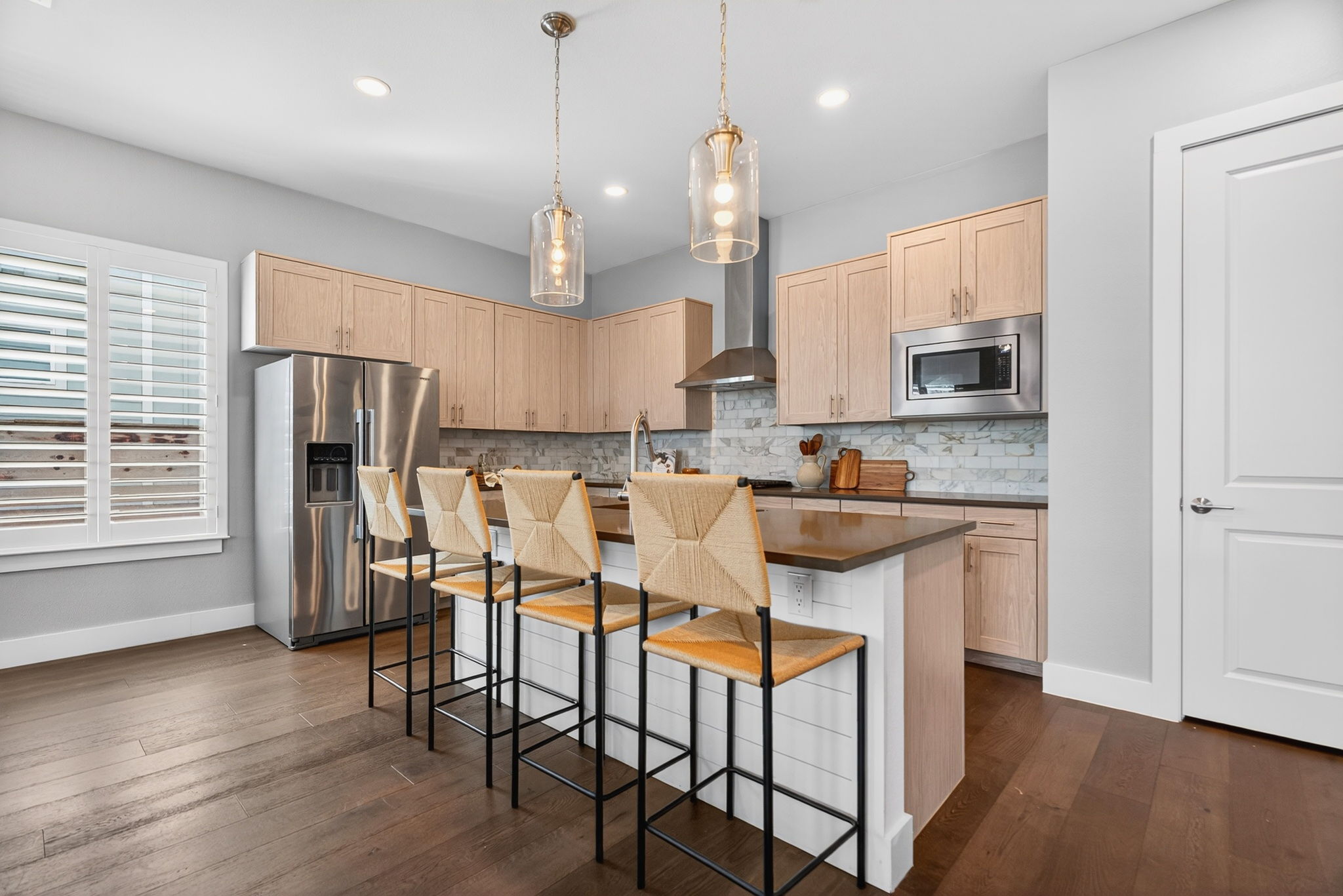 7803 Ryans Way Austin, TX 78726 - Photo 6 of 38 Breakfast bar seating provides casual dining and entertaining space.