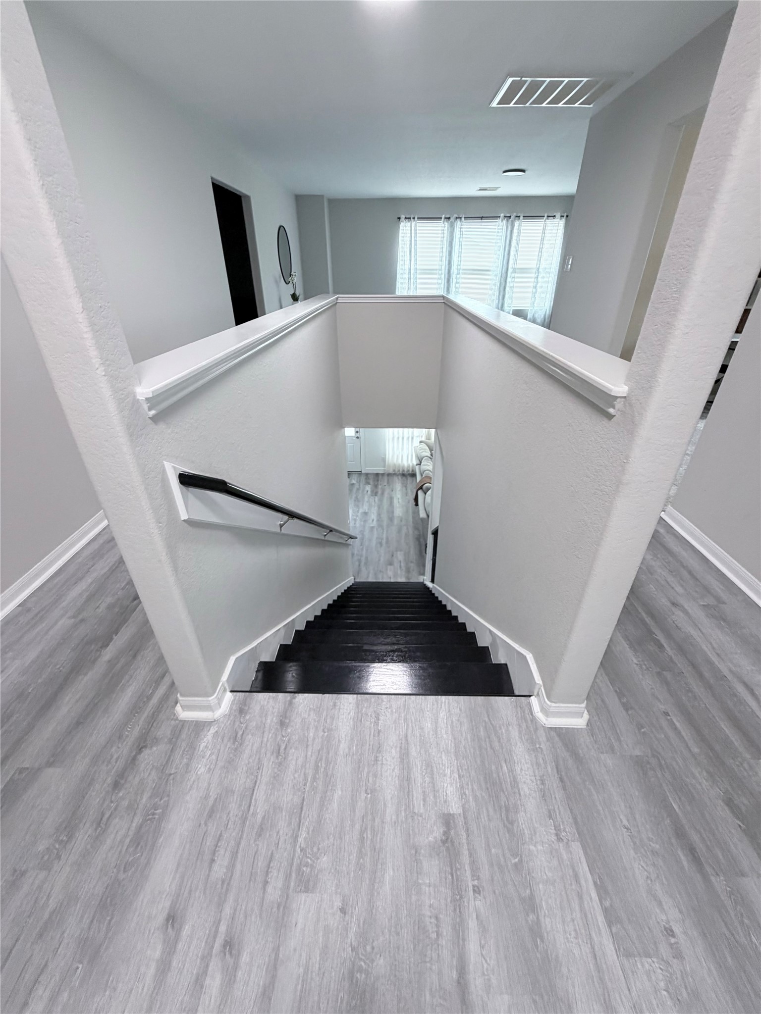 3226 Dappled Vale Trail Spring, TX 77373 - Photo 21 of 26 This photo shows a modern staircase with dark wood steps.