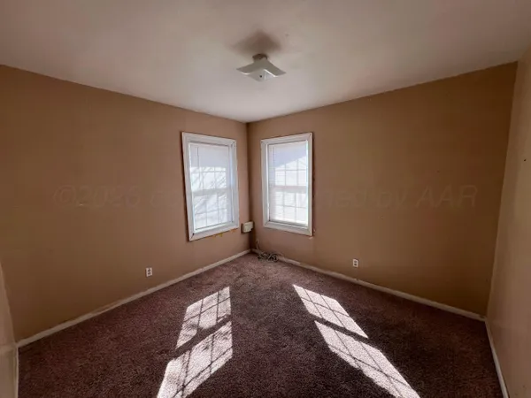 a view of an empty room with closet area