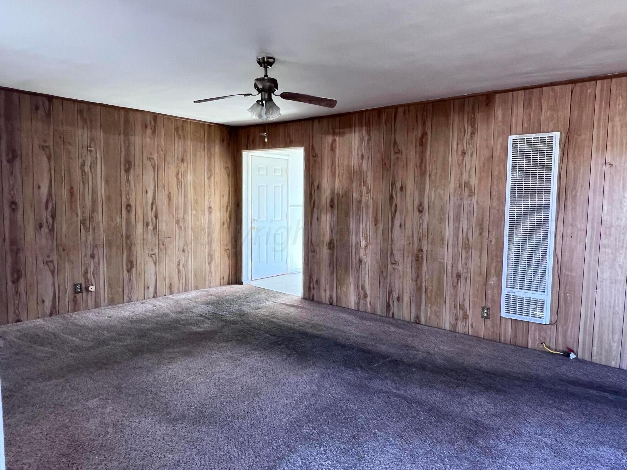 828 Blevins Street Hereford, TX 79045 - Photo 6 of 14 a view of empty room with windows