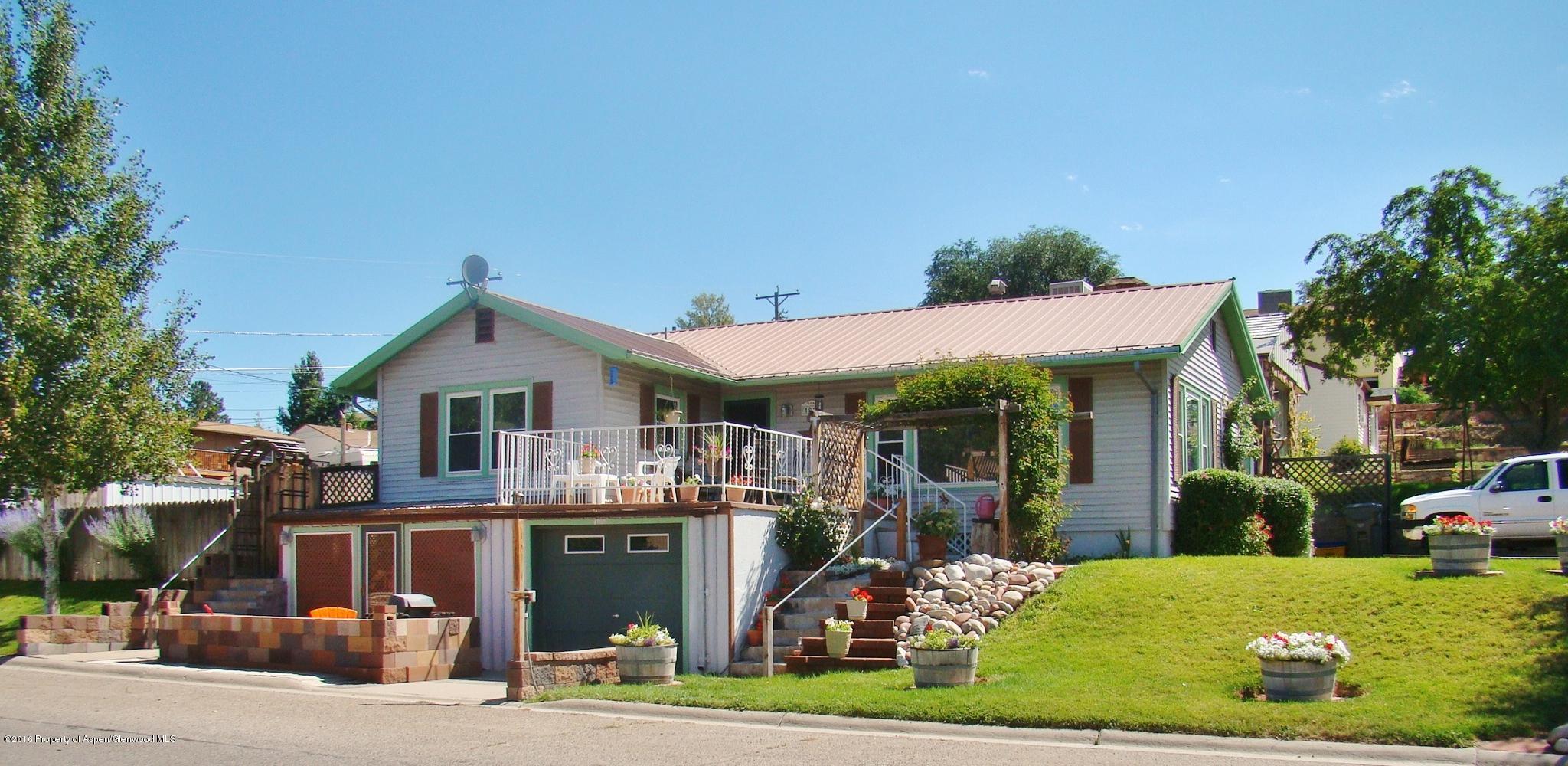1010 Munro Avenue Rifle, CO 81650 - Photo 1 of 23 a front view of a house with a yard