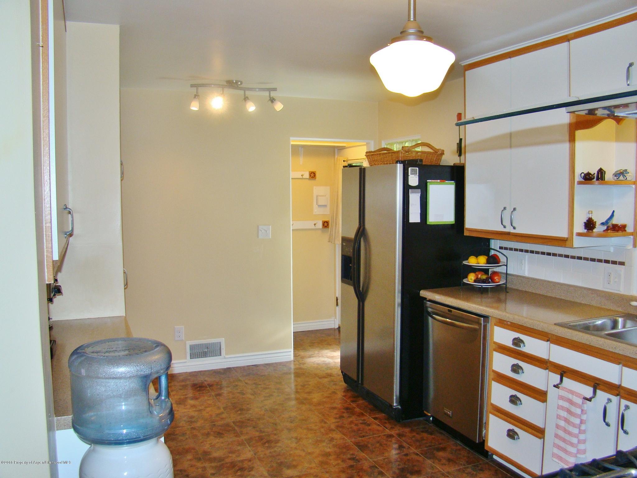 1010 Munro Avenue Rifle, CO 81650 - Photo 8 of 23 a kitchen with stainless steel appliances a refrigerator and a stove