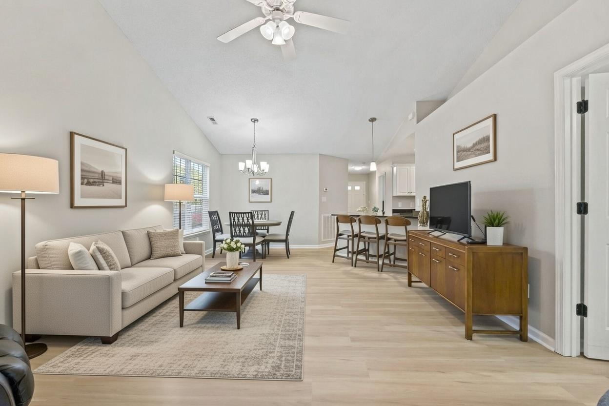 135 Country Manor Drive, Unit B Conway, SC 29526 - Photo 11 of 40 Living room with lofted ceiling, light wood-style floors, ceiling fan, and a chandelier
